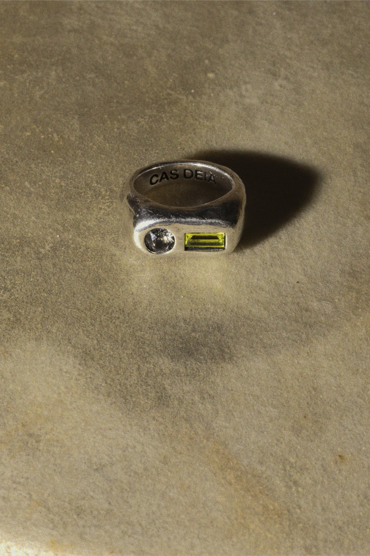 CAS DEIÀ COSTA RING OLIVE GREEN, handcrafted ring with a silver finish, still life